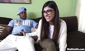beauty Mia Khalifa supplies a hand job to a big dicked black dude for starters