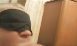 aroused blonde with a blindfold on her eyes is deep throat a dick